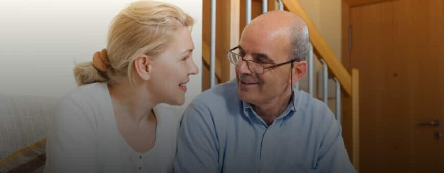 An older couple smiling and discussing the best mortgage option